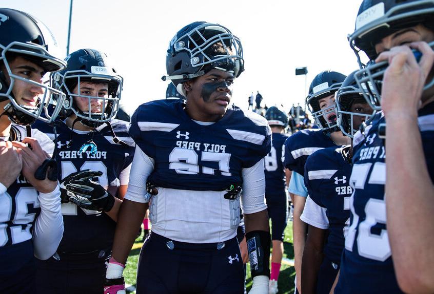 Poly Prep Varsity Football team in a huddle